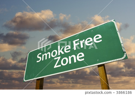 smoke free zone green road sign and clouds 3866186