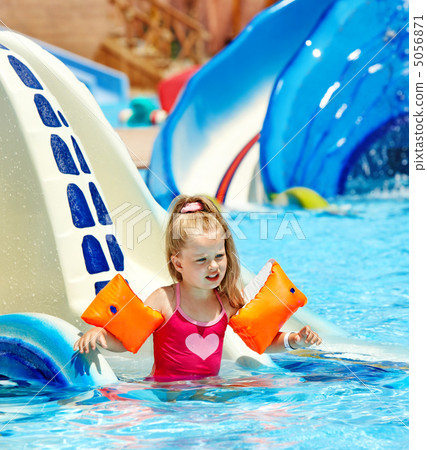 child with armbands playing in swimming pool. 5056871