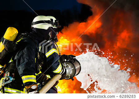 firefighter - firemen extinguishing a large blaze