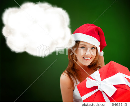 young happy girl in christmas hat. holding huge christmas gift.