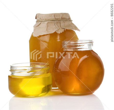 图库照片: pot of honey and jar isolated on white