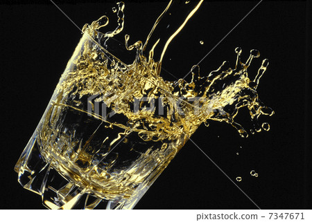 stock photo: splashes of whiskey overflowing vigorously into