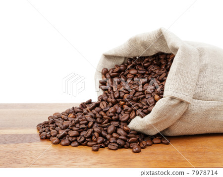 图库照片: roated coffee beans spill out of the bag