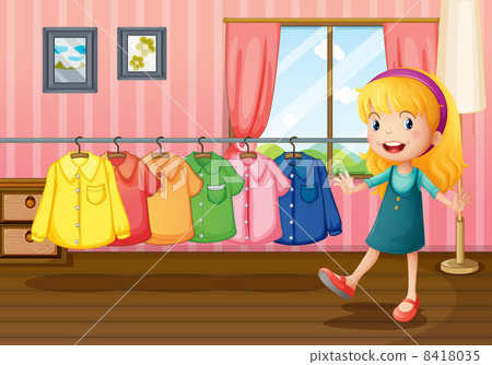 a girl beside the hanging clothes inside the house