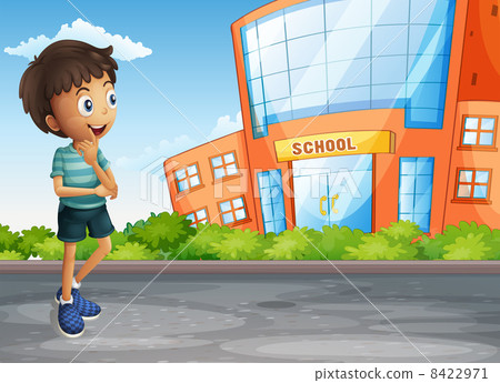 图库插图: a young boy at the street across the school building