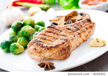 图库照片: grilled pork chop with brussels sprouts