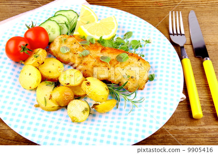 fried fish fillet with vegetables and rosemary potatoes 9905416