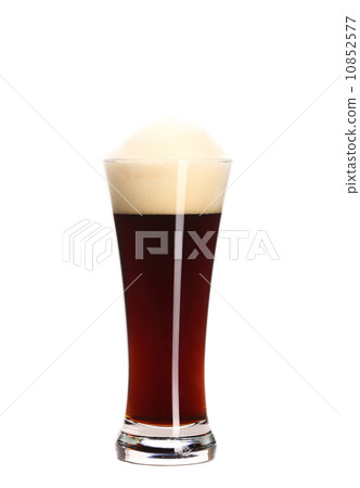 glass of brown beer with foam.