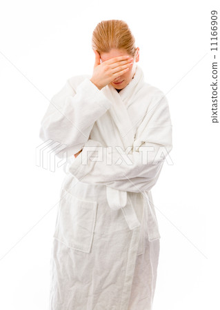 照片素材(图片): young woman standing in bathrobe covering her