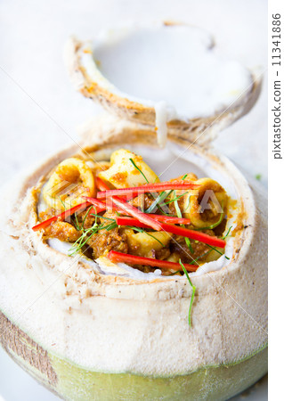 图库照片: red curry seafood in coconut fruit, thai food