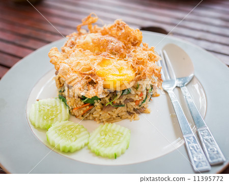 fried egg jellyfish,turtle frog basil beef fried rice topped with a fried egg
