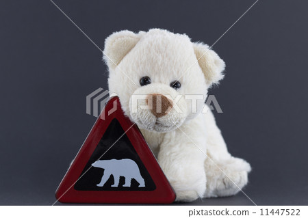 图库照片: cute polar bear cub with warning sign