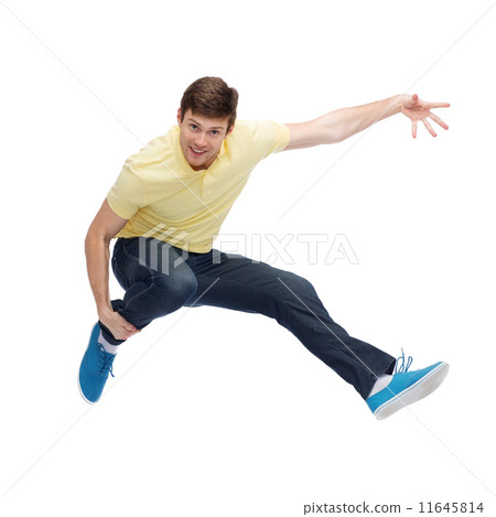 图库照片: smiling young man jumping in air