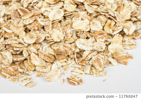 图库照片: heap of dry rolled oats isolated on white background