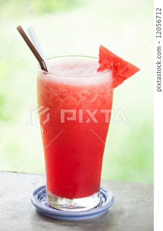 图库照片: red water melon fruit juice frappe with green bokeh