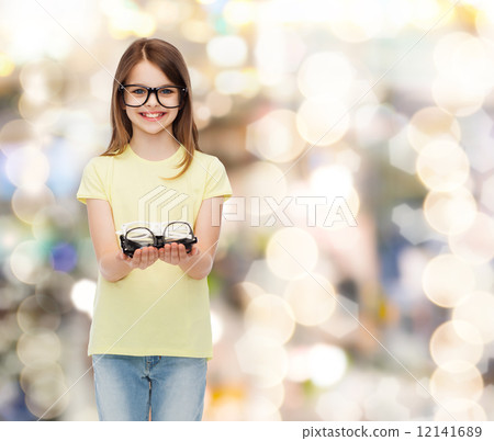 图库照片: smiling cute little girl in black eyeglasses