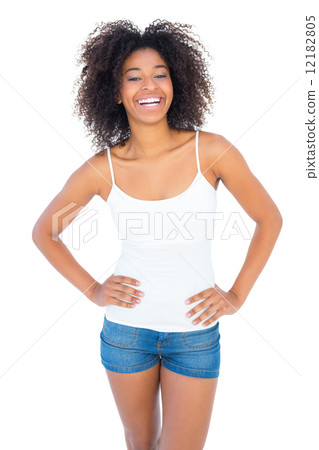 pretty girl in white top and denim hot pants smiling at camera