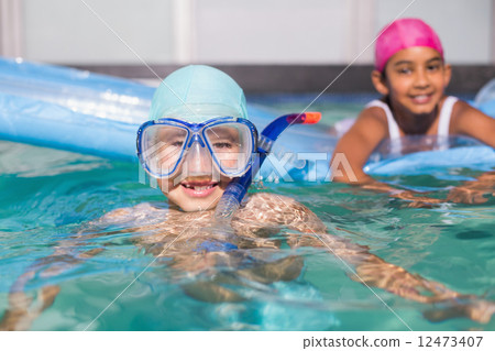 图库照片: cute little kids swimming in the pool