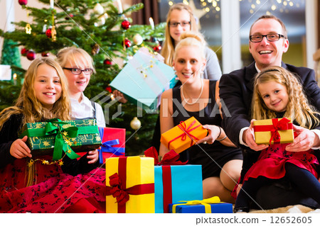 图库照片: family with lots of christmas presents under tree