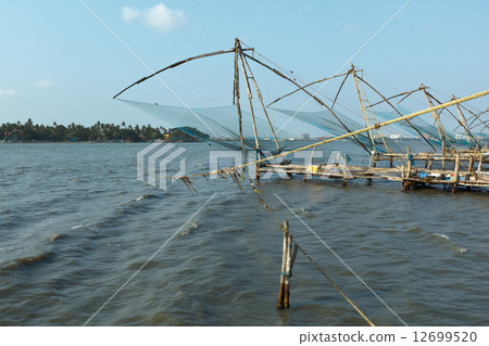 图库照片: chinese fishnets on sunset. kochi, kerala, india