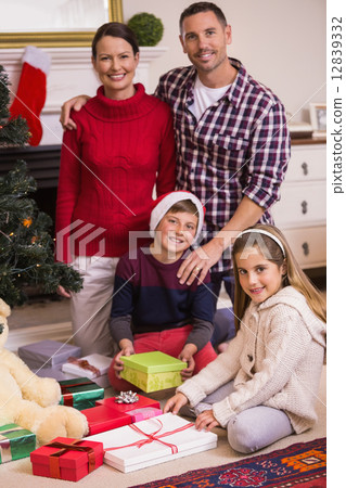 照片素材(图片): happy family opening present at christmas