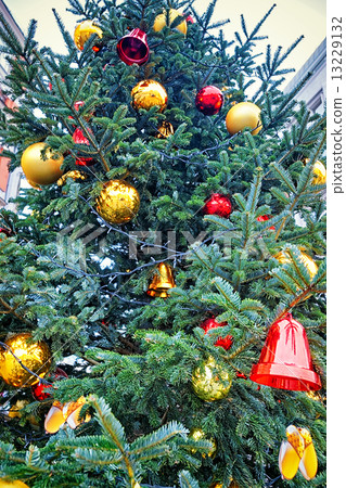 red and golden decorating bells and balls on the christmas tree