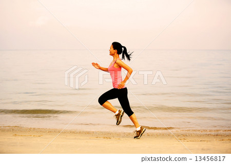 图库照片: fitness sports woman running seaside beach