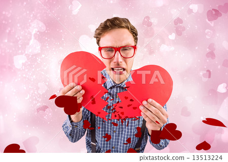 composite image of geeky hipster holding a broken heart