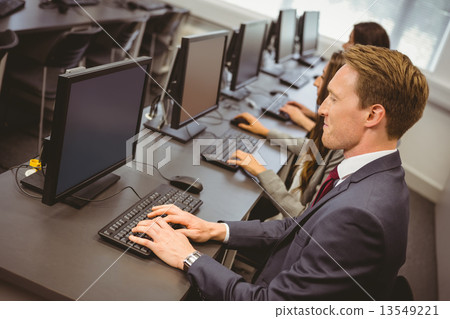 computerroom图片,computer图片 图库照片: three focused people working in computer room