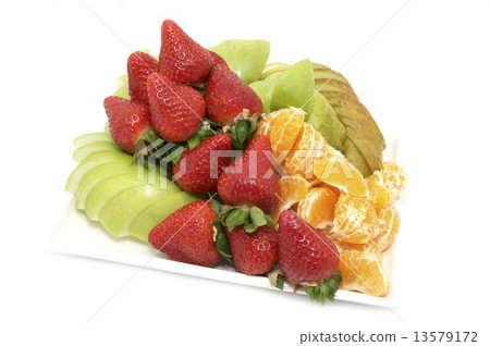 图库照片: plate of ripe juicy fruit on white background