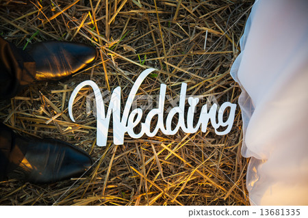 照片素材(图片): feet of groom and bride. white wedding letters