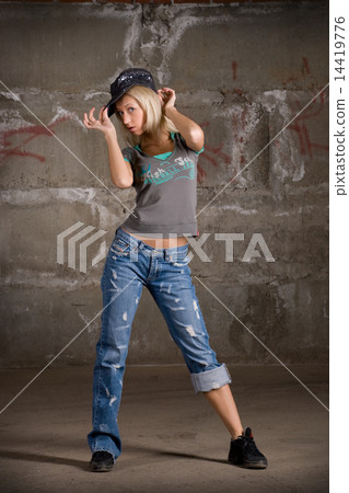 图库照片 beautiful hip hop girl dancing over grey brick wall