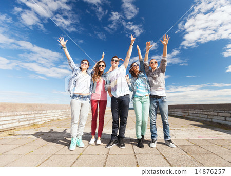 图库照片: group of teenagers holding hands up