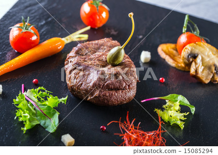 图库照片: grilled beef steak with vegetable decoration.