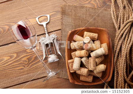 图库照片: red wine glass, corkscrew and bowl with corks