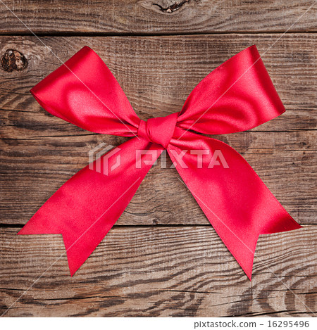 图库照片: red bow on the old board