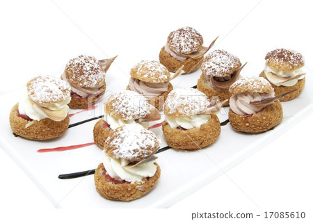 图库照片: profiteroles with vanilla ice cream decorated with