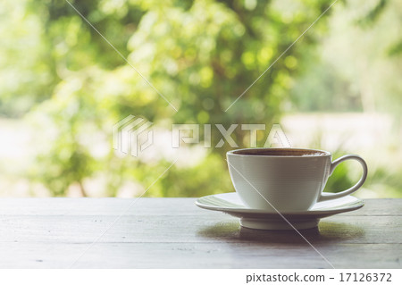 图库照片: white coffee cup on the table at morning time