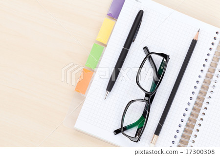 图库照片: office table with glasses, notepad, pen and pencil