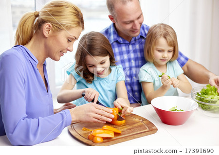 图库照片: happy family with two kids cooking at home