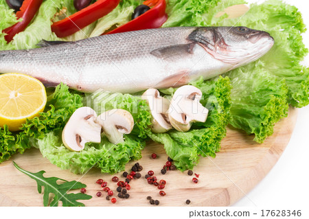 图库照片: fresh seabass fish on lettuce.