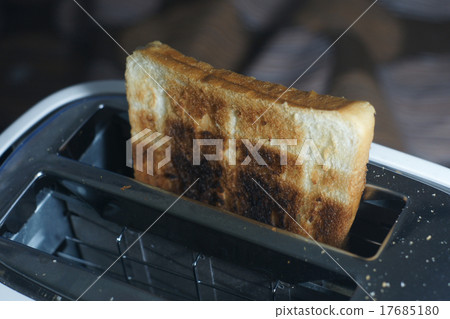 图库照片: white dirty toaster,burned toast (selective focus)