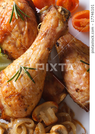 图库照片: fried chicken legs with mushrooms macro top view