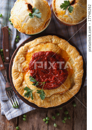 图库照片: delicious meat pies on a table. vertical top view