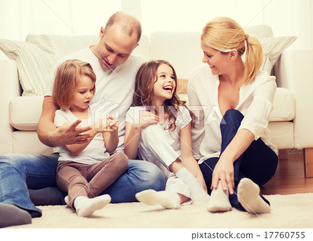 girlsand欧美,pacificgirls 图库照片: parents and two girls sitting on floor at home