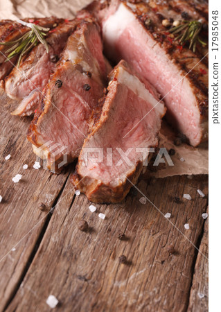 图库照片: sliced beef steak medium on an old table close-up