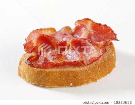 a slice of meat,a bucket of milk 图库照片: crispy slice of pork meat on bread