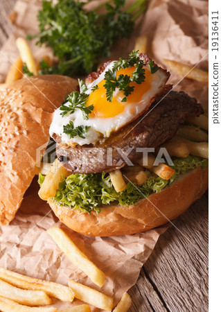 图库照片: sandwich with beefsteak, fried egg and fries