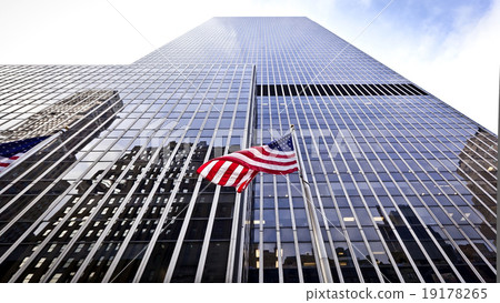 图库照片: flag of the usa in front of the office building.