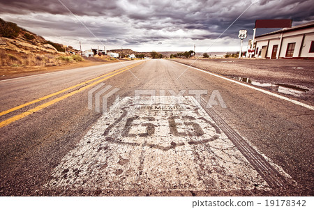 照片素材(图片): an old route 66 shield painted on road